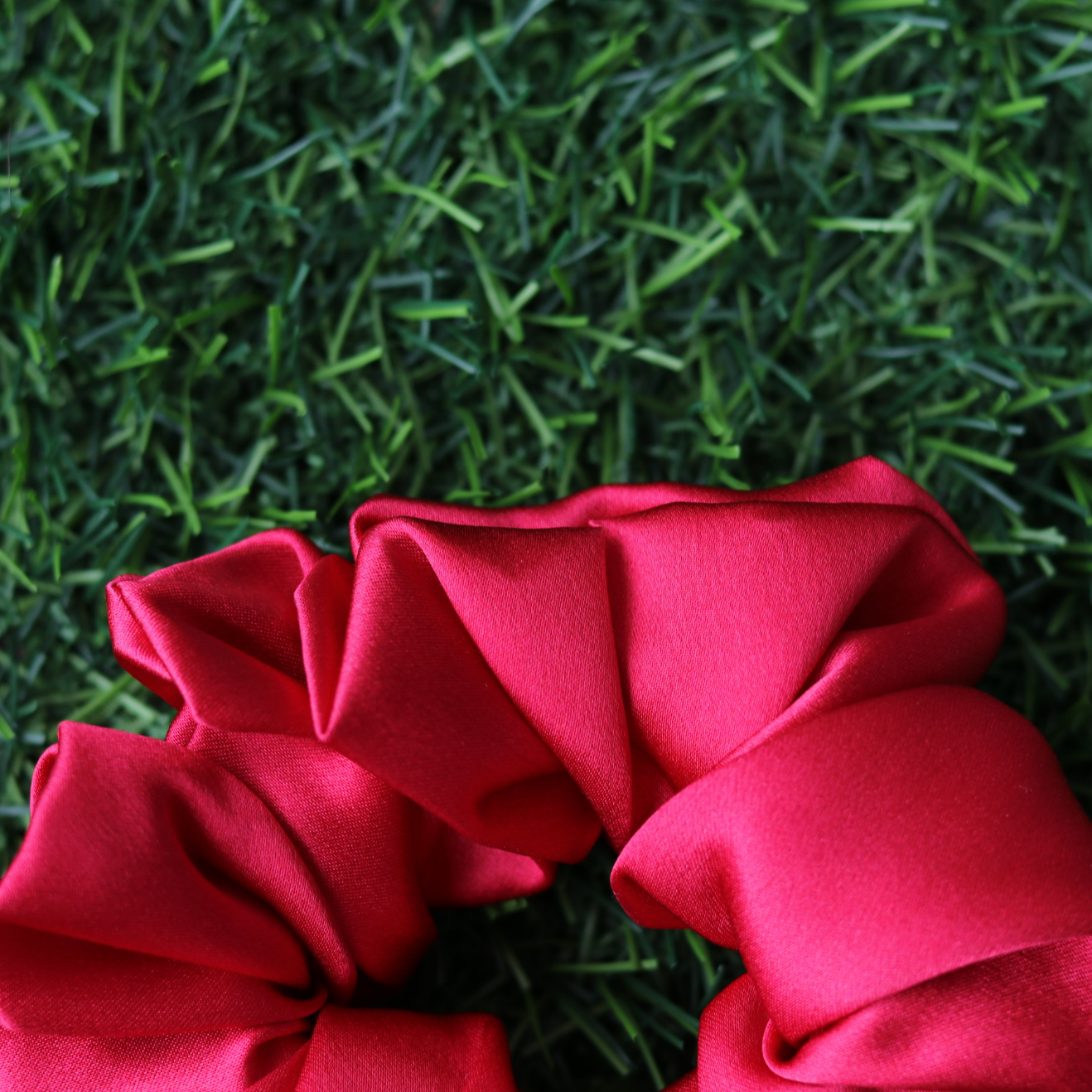 Red scrunchie on artificial grass