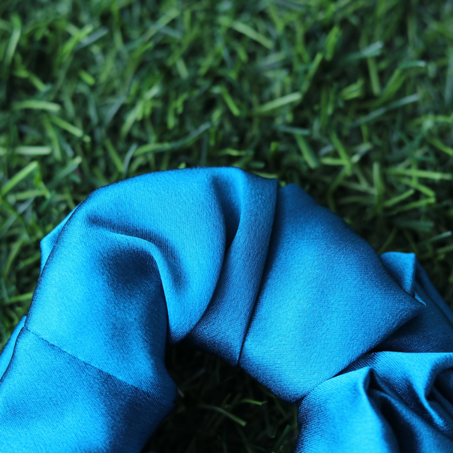 Blue scrunchie on artificial grass